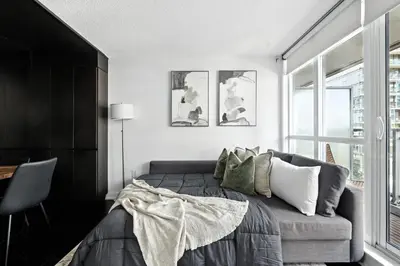 a bedroom with a bed and a window at Modern CityPlace Retreat King Bed & Balcony in Toronto