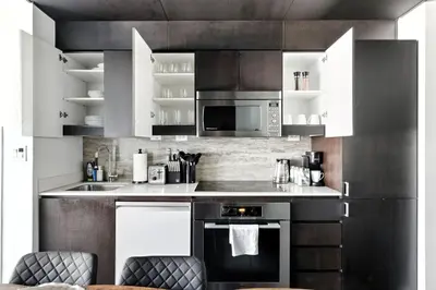 a kitchen with a stove and a microwave at Modern CityPlace Retreat King Bed & Balcony in Toronto