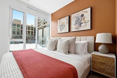 a bedroom with a bed and a large window at Stunning 2BR Downtown Condo w Huge Private Patio in Toronto