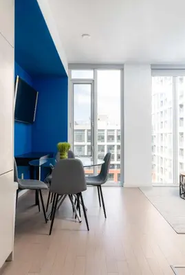a dining room with blue walls and a table and chairs at Designer 1BR Condo Entertainment District in Toronto