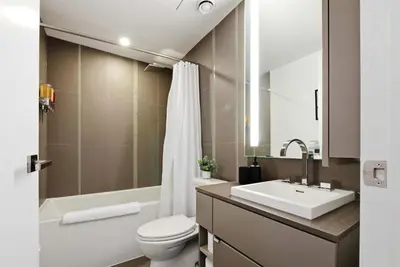 a bathroom with a sink and a toilet and a tub at Heart of the City 1BR Condo Walk Everywhere in Toronto