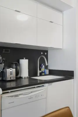 a kitchen with a sink and a counter top at Modern Downtown Retreat Cozy Living & City Views in Toronto