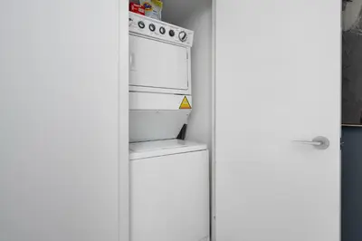 a white refrigerator with its door open in a kitchen at Modern CityPlace Sky Home 2BR 2BA & Balcony in Toronto