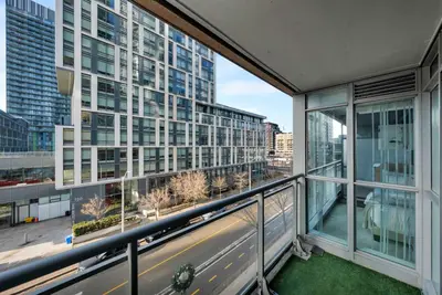 an apartment balcony with a view of a city at Modern CityPlace Sky Home 2BR 2BA & Balcony in Toronto