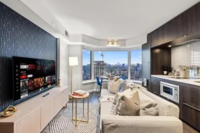 a living room with a large flat screen tv at Sleek Yorkville King Suite Sleeps 5 DT in Toronto