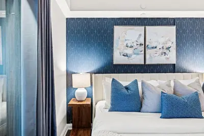 a bedroom with a bed with blue and white at Sleek Yorkville King Suite Sleeps 5 DT in Toronto