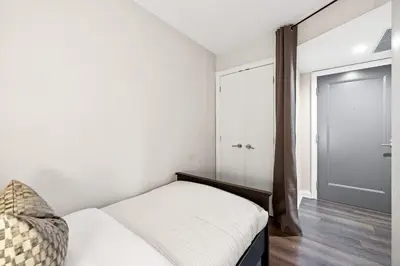 a bedroom with a bed and a sliding door at Sleek Yorkville King Suite Sleeps 5 DT in Toronto