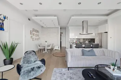 a living room with a couch and a table at Luxury Parklawn Penthouse Breathtaking Lake View in Toronto