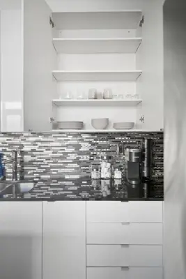 a kitchen with white cabinets and a counter top at Luxury Parklawn Penthouse Breathtaking Lake View in Toronto