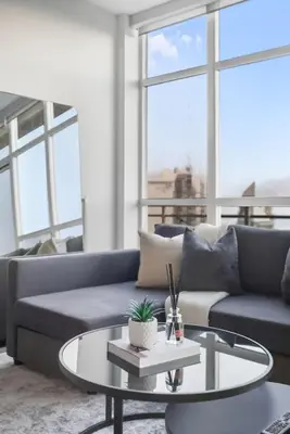 a living room with a couch and a coffee table at Luxury Parklawn Penthouse Breathtaking Lake View in Toronto