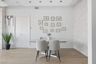 a dining room with a table and two chairs at Luxury Parklawn Penthouse Breathtaking Lake View in Toronto