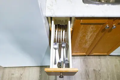 a kitchen counter with silver utensils on a holder at Downtown Oasis Sleek Suite by Yonge Dundas Sq in Toronto