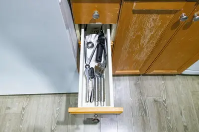 a group of utensils hanging from a cabinet at Downtown Oasis Sleek Suite by Yonge Dundas Sq in Toronto