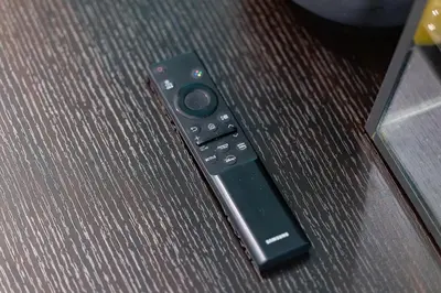 a remote control sitting on top of a couch at Downtown Oasis Sleek Suite by Yonge Dundas Sq in Toronto