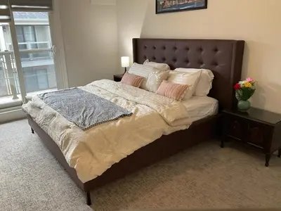 a bedroom with a large bed with pillows at 3bed Bright Oakville Townhome with balcony, office in Oakville