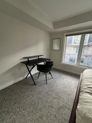 a room with a desk and a bed and a window at 3bed Bright Oakville Townhome with balcony, office in Oakville