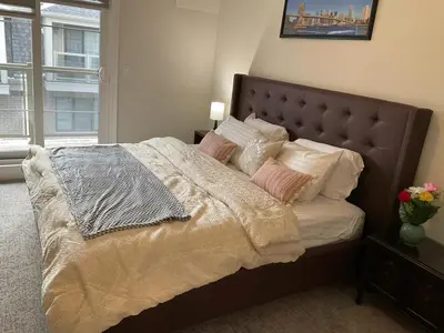 a bedroom with a large bed with pillows at 3bed Bright Oakville Townhome with balcony, office in Oakville
