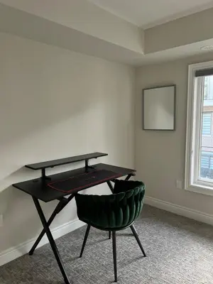 a ping pong table and a green chair in a room at 3bed Bright Oakville Townhome with balcony, office in Oakville