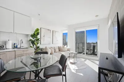 a kitchen and living room with a glass table at Stunning Family-Friendly Parking & City Views in Toronto