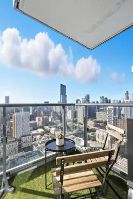 a balcony with a table and bench and a view of the city at Stunning Family-Friendly Parking & City Views in Toronto