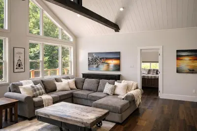 a living room with a couch and a table at Waterfront Muskoka Cottage with FirePit, BBQ and Canoes in Bracebridge