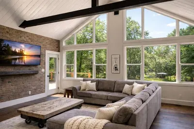 a living room with a couch and a fireplace at Waterfront Muskoka Cottage with FirePit, BBQ and Canoes in Bracebridge