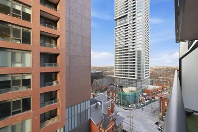 an aerial view of a city with a tall building at Cozy 1BR Condo w Private Patio for Morning Coffee in Toronto