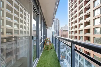 a chair on the balcony of a building at Cozy 1BR Condo w Private Patio for Morning Coffee in Toronto