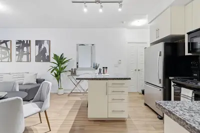 a kitchen with a refrigerator and a counter top at Cozy 1BR Condo w Private Patio for Morning Coffee in Toronto