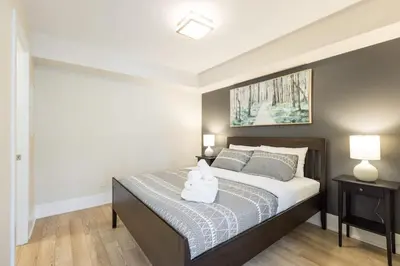 a bedroom with a bed with two pillows on it at Modern 1BR Retreat with Balcony & Parking in Toronto