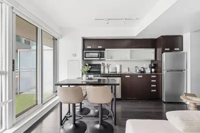 a kitchen with a table and chairs in a room at Modern 1BR in Liberty Village Walk Score 90 in Toronto