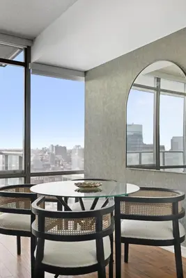 a dining room with a table and chairs and a window at Chic Bay St Condo Skyline Views 55 TV in Toronto