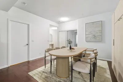 a dining room with a table and chairs at Designer Bay Street Condo Sleep 6 in Toronto