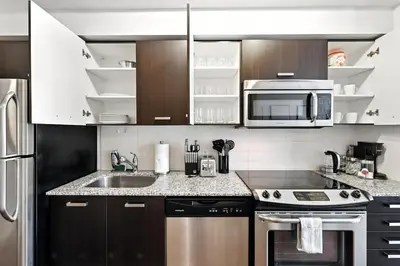 a kitchen with a sink and a microwave at Financial District Oasis Sleeps 5 55 TV in Toronto