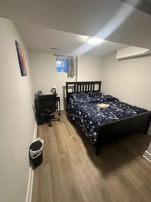 a bedroom with a bed and a desk at Cozy Parkside 2 Bedroom Basement Suite in Vaughan