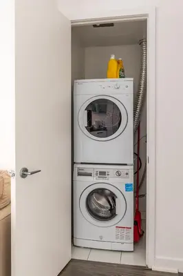 a washer and dryer in a small room at Modern Studio Condo High Floor Downtown Toronto in Toronto