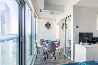 a dining room with a table and chairs at Modern Studio Condo High Floor Downtown Toronto in Toronto