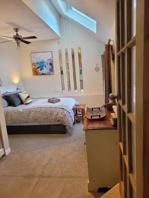 a bedroom with a bed and a desk in a room at Forest View Secluded Serene in Hamilton