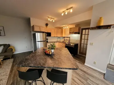 a kitchen with a table with a bowl of fruit on it at Forest View Secluded Serene in Hamilton