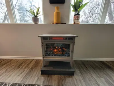 a fireplace in the corner of a living room at Forest View Secluded Serene in Hamilton