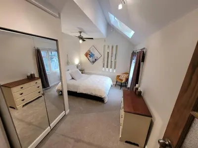 a bedroom with a bed and a dresser and a mirror at Forest View Secluded Serene in Hamilton