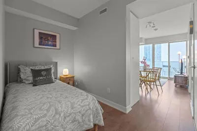 a bedroom with a bed and a view of the ocean at New Cozy 1 Bedroom & Den Condo in Downtown Toronto in Toronto