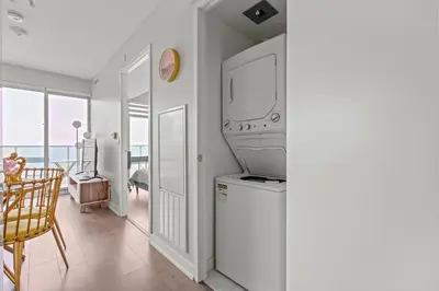 a living room with a tv on the wall at New Cozy 1 Bedroom & Den Condo in Downtown Toronto in Toronto