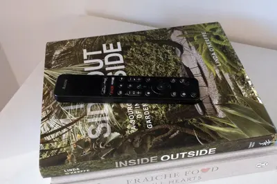 a remote control sitting on top of a book at Propercare - The Wellingtons in Kitchener