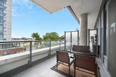 two chairs on a balcony with a view at Propercare - The Wellingtons in Kitchener
