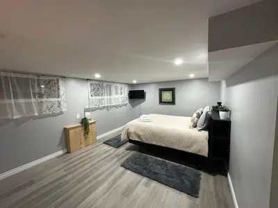 a bedroom with a bed in a room with at 1 Bedroom Basement with parking and Backyard in Hamilton