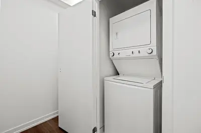 a washer and dryer in a kitchen with a refrigerator at Cozy 2 Bedroom Condo in Dunfield Ave Downtown Toronto in Toronto