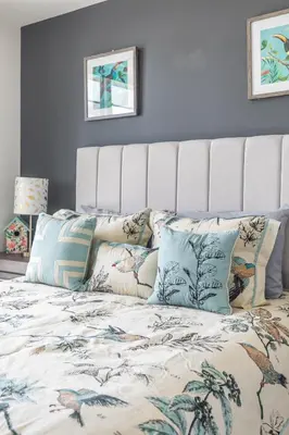 a bedroom with a bed with blue walls at Paradise Birds 1 Bedroom Condo in Downtown Toronto in Toronto