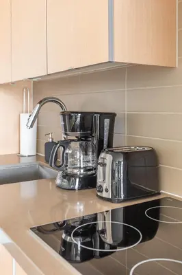 a coffee maker and toaster sitting on a kitchen counter at Paradise Birds 1 Bedroom Condo in Downtown Toronto in Toronto