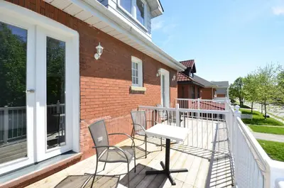 a patio with two chairs and a table on a balcony at Ambassador B&B Guest Home in Stratford